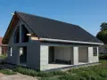 Dom w stanie surowym otwartym, z dachem pokrytym czarną dachówką. Ściany z bloczków betonowych, widoczne otwory okienne i drzwiowe.