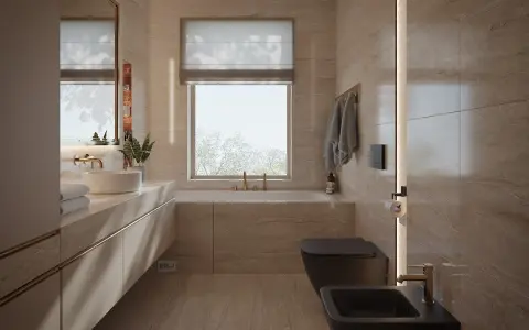 Nowoczesna łazienka z oknem na wprost drzwi, wanna, czarna miska WC i bidet, kamienne płytki, złote baterie.
